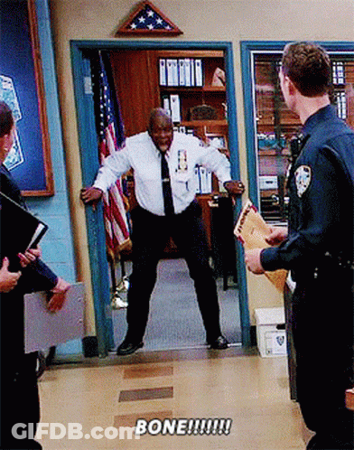 Man In White Shirt And Tie Standing In Doorway Saying Bone GIF
