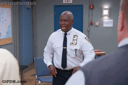 Man In White Shirt And Tie Standing In Front Of Party Sign GIF