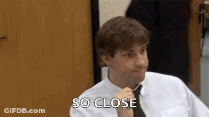 Man In White Shirt And Tie Talking At Table GIF