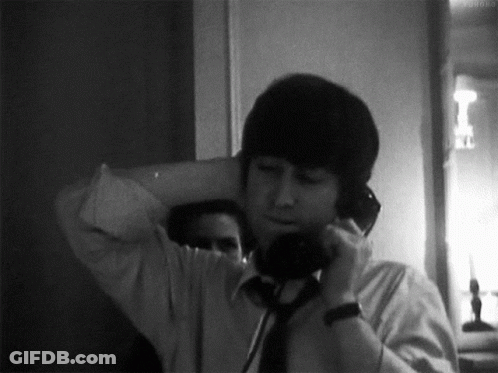 Man In White Shirt And Tie Talking On Phone GIF
