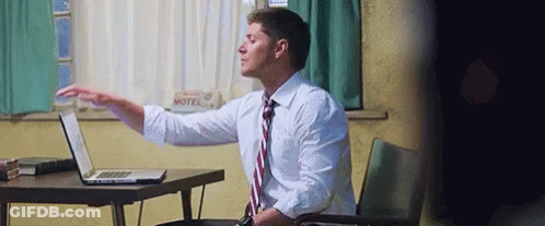 Man In White Shirt And Tie Using Laptop GIF