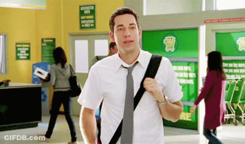 Man In White Shirt And Tie Walking Through Store GIF
