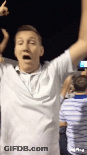 Man In White Shirt Arms In Air GIF