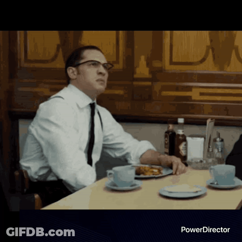 Man In White Shirt At Table With Food GIF