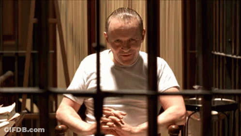 Man In White Shirt Behind Bars GIF