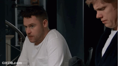 Man In White Shirt Beside Man In Black Robe GIF