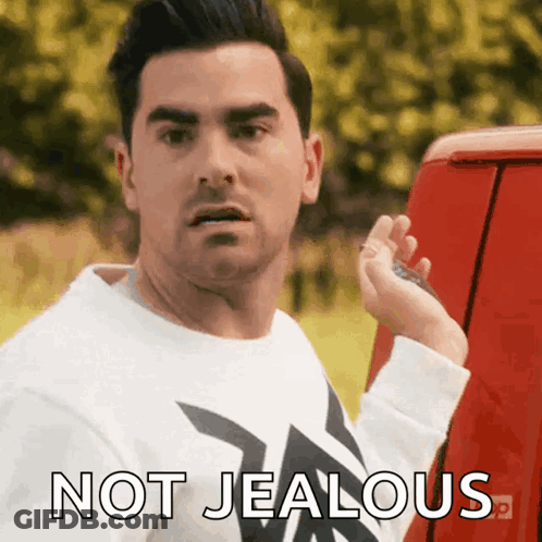 Man In White Shirt Beside Red Van Not Jealous GIF
