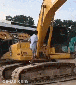 Man In White Shirt Beside Yellow Excavator Saying Cat GIF