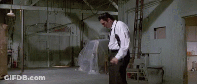 Man In White Shirt Black Pants Holding Gun GIF