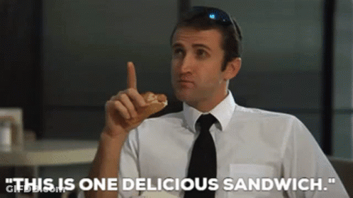 Man In White Shirt Black Tie Eating Sandwich This Is One Delicious Sandwich GIF