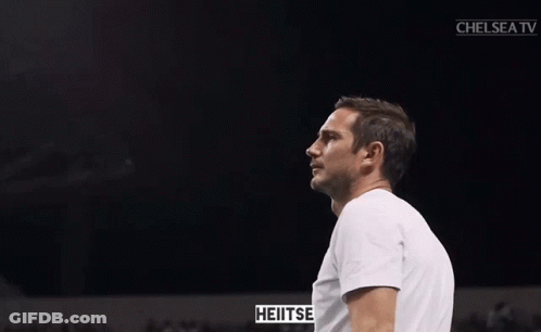 Man In White Shirt Clapping In Front Of Chelsea TV Screen GIF