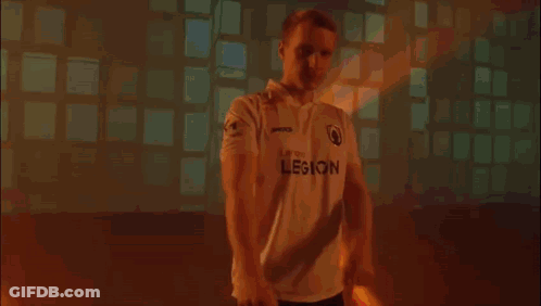 Man In White Shirt Covering Face In Dark Room GIF