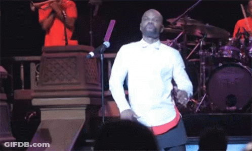 Man In White Shirt Dancing At Microphone GIF