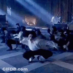 Man In White Shirt Dancing In Dark Room GIF