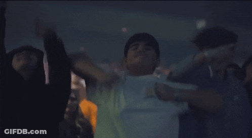 Man In White Shirt Dancing In Dark Room GIF