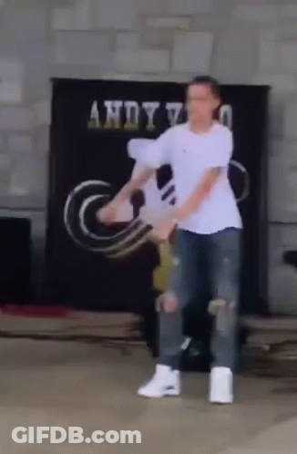 Man In White Shirt Dancing In Front Of Andy Sign GIF