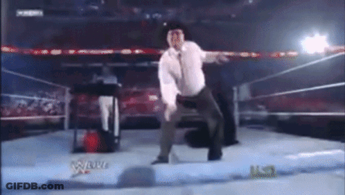 Man In White Shirt Dancing In Wrestling Ring GIF