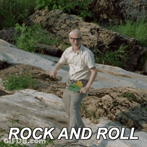 Man In White Shirt Dancing On Rock GIF