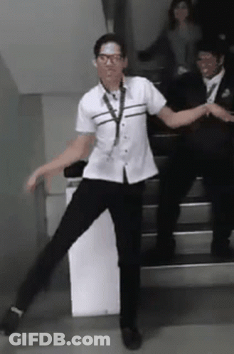 Man In White Shirt Dancing On Stairs GIF