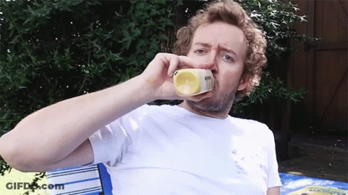 Man In White Shirt Drinking Yellow Container GIF