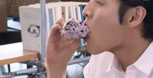 Man In White Shirt Eating Doughnut GIF