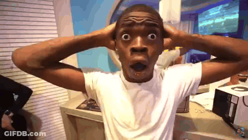 Man In White Shirt Hands On Head Mouth Open GIF