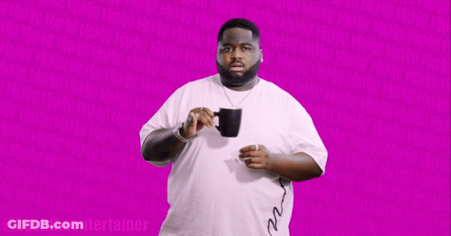Man In White Shirt Holding Black Mug Says Bashthe Entertainer GIF