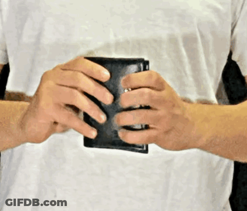 Man In White Shirt Holding Black Wallet GIF