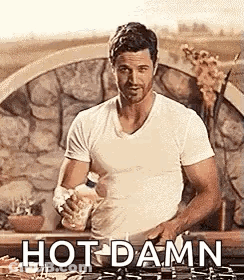Man In White Shirt Holding Bottle By Stove GIF