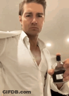Man In White Shirt Holding Bottle Of Perfume GIF
