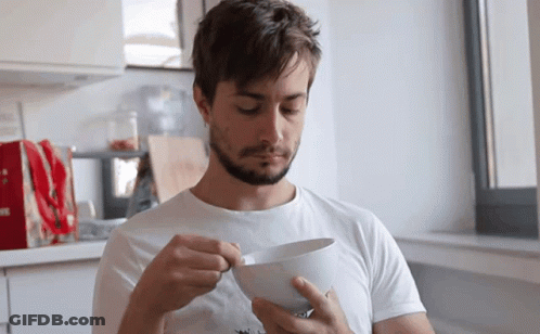 Man In White Shirt Holding Bowl Of Food GIF