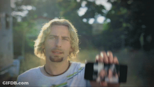 Man In White Shirt Holding Cell Phone GIF