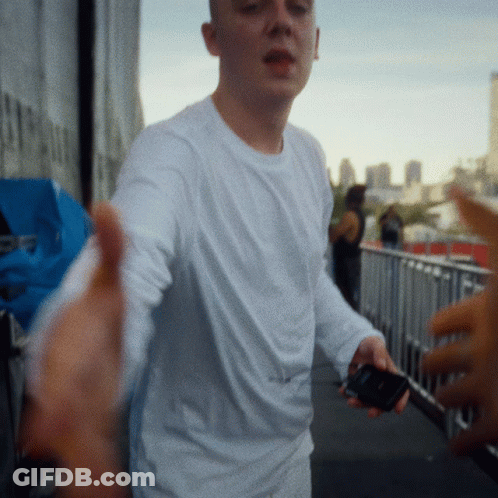 Man In White Shirt Holding Cell Phone GIF
