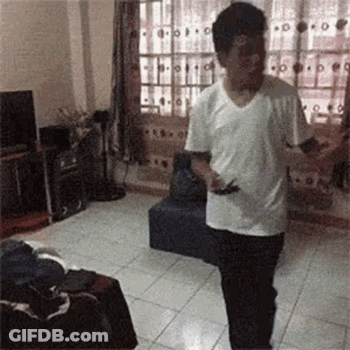 Man In White Shirt Holding Cell Phone GIF