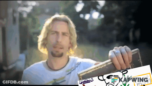 Man In White Shirt Holding Chone Can GIF