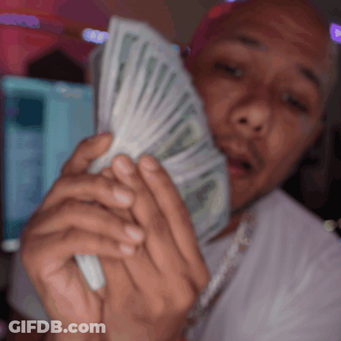 Man In White Shirt Holding Fan Of Money GIF