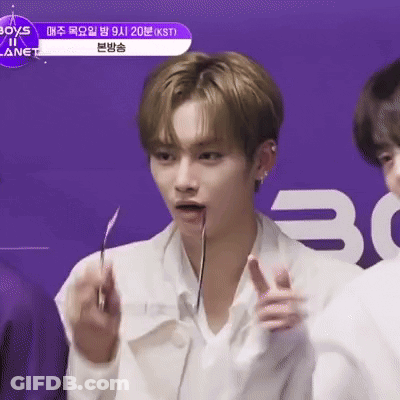 Man In White Shirt Holding Knife In Mouth And Pointing GIF