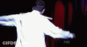 Man In White Shirt Holding Knife In Mouth In Front Of Fox GIF