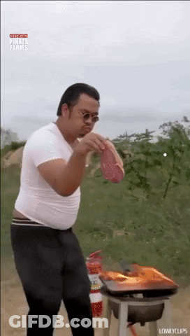 Man In White Shirt Holding Meat GIF