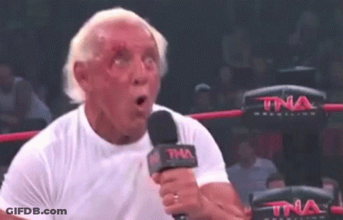 Man In White Shirt Holding Microphone Making Funny Face GIF