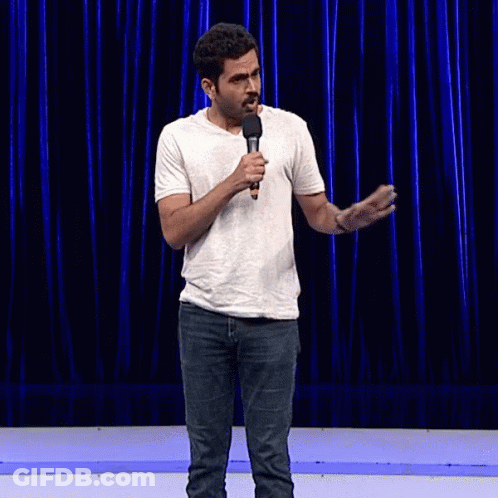 Man In White Shirt Holding Microphone Making Funny Face GIF