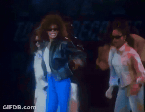 Man In White Shirt Holding Microphone On Stage GIF