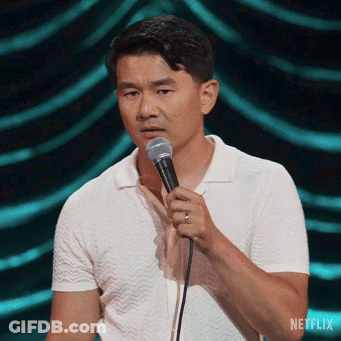 Man In White Shirt Holding Microphone With Netflix Logo GIF