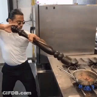 Man In White Shirt Holding Pepper Mill GIF