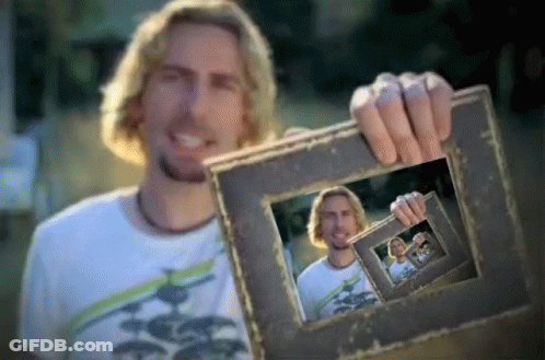Man In White Shirt Holding Picture Frame Of Himself GIF