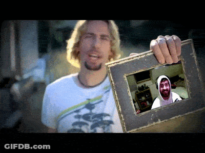 Man In White Shirt Holding Picture Of Man In Hoodie GIF