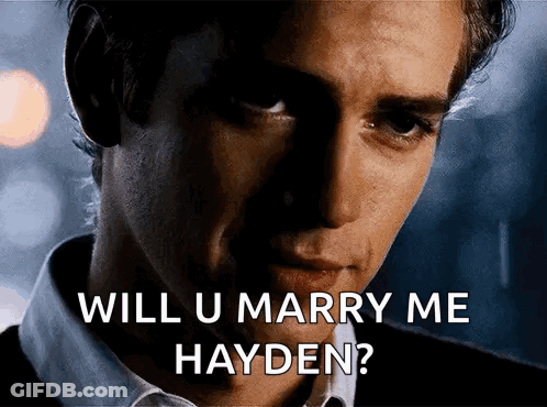 Man In White Shirt Holding Pink Container With Hayden Mi Amor GIF