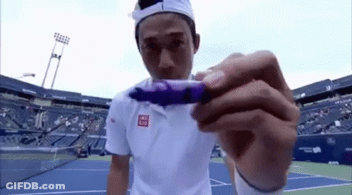 Man In White Shirt Holding Purple Item GIF