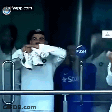 Man In White Shirt Holding Shoes GIF