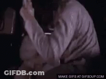 Man In White Shirt Holding Something GIF